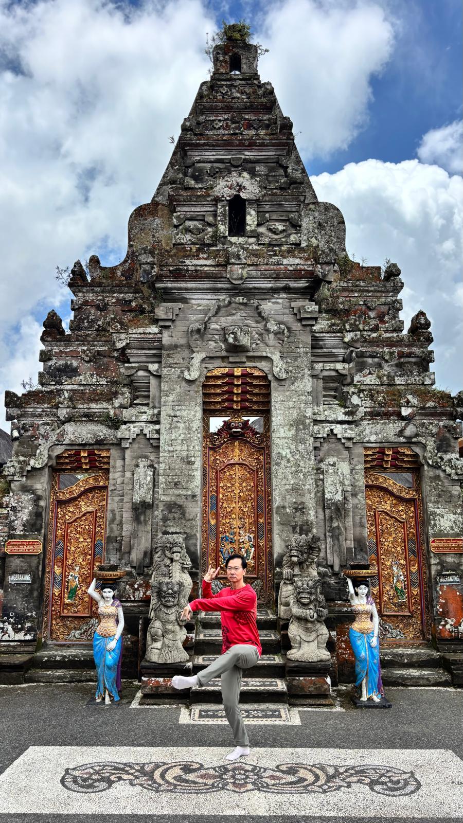 Victor Chng in a martial arts stance at a Balinese temple gate